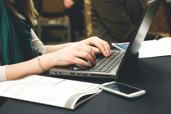 Girl blogging on laptop computer