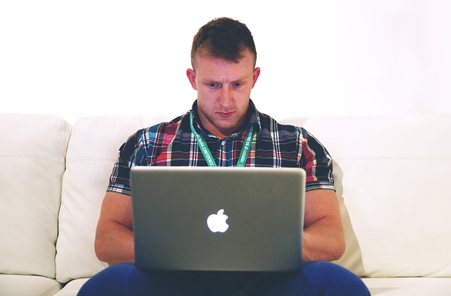 Man blogging on laptop computer