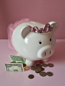 Piggy bank with paper and coin currency