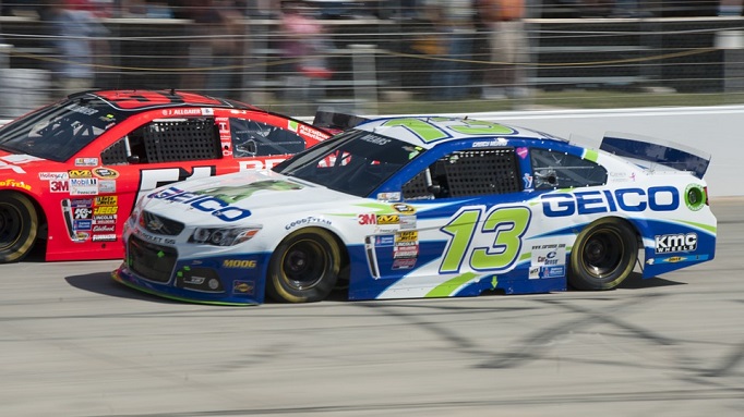 The Geico NASCAR car number 15 side by side trying to pass another car