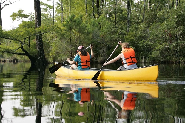 two people in a canoe on a lake