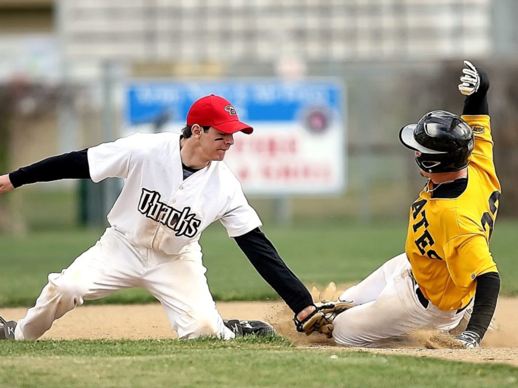 Baseball player being tagged out at second base